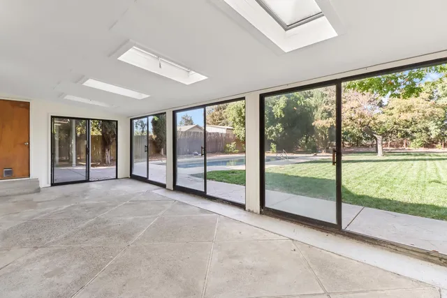 a view of a yard with plants and trees