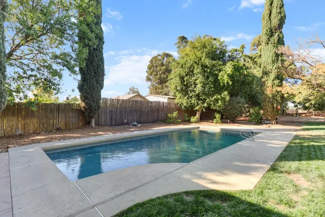 a view of a street with some trees in the background