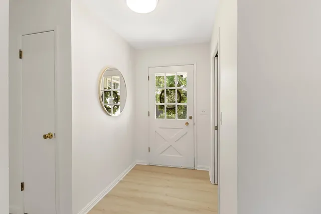 a view of an entryway with wooden floor