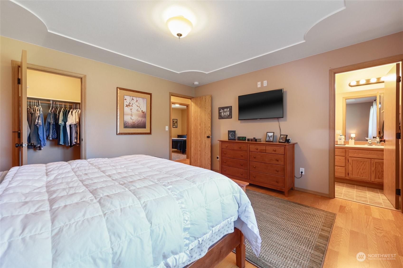 17330 Privet Court Southwest Rochester, WA 98579 - Photo 20 of 25 a spacious bedroom with a bed and a flat screen tv