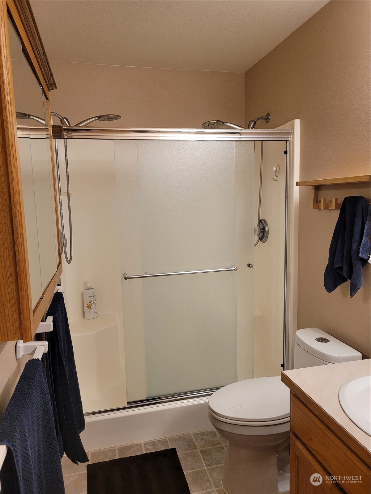 17330 Privet Court Southwest Rochester, WA 98579 - Photo 22 of 25 a bathroom with a shower a toilet and a sink