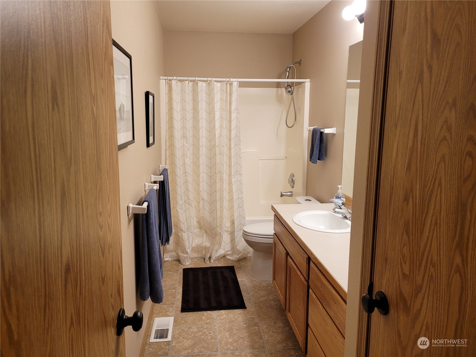 17330 Privet Court Southwest Rochester, WA 98579 - Photo 25 of 25 a bathroom with a double vanity sink a mirror and a tub