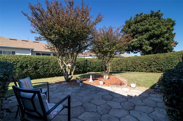 a backyard of a house with table and chairs