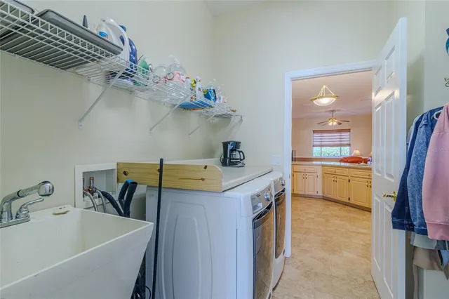 a utility room with a sink a washer and dryer