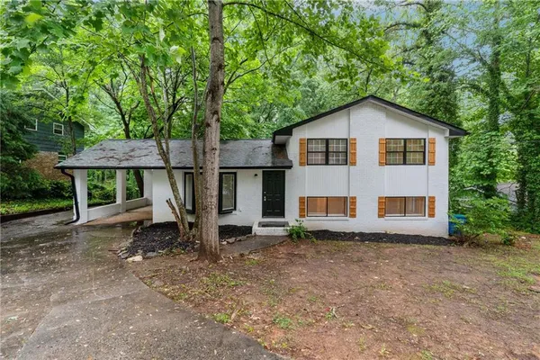 a view of backyard of house with green space