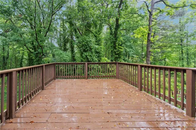 a view of balcony with wooden floor and fence