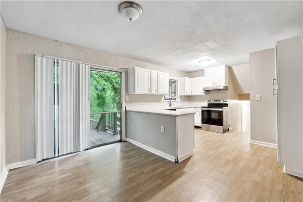 a kitchen with white cabinets and white appliances