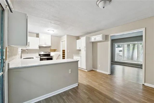 a kitchen with stainless steel appliances a refrigerator and a stove top oven