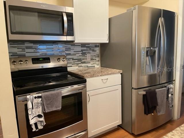 2305 Northeast 38th Street Ocala, FL 34479 - Photo 27 of 34 a kitchen with a refrigerator stove and microwave