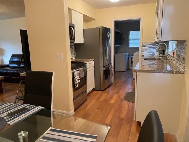2305 Northeast 38th Street Ocala, FL 34479 - Photo 5 of 34 a kitchen with a refrigerator and a stove top oven