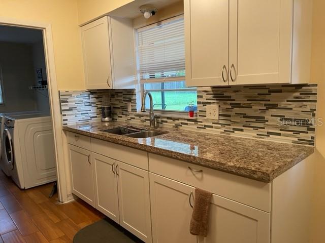 2305 Northeast 38th Street Ocala, FL 34479 - Photo 10 of 34 a kitchen with stainless steel appliances granite countertop a sink a stove and a microwave