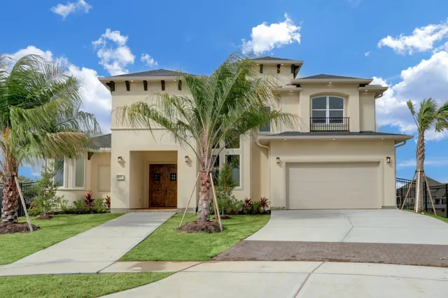 a front view of a house with a yard and a garage