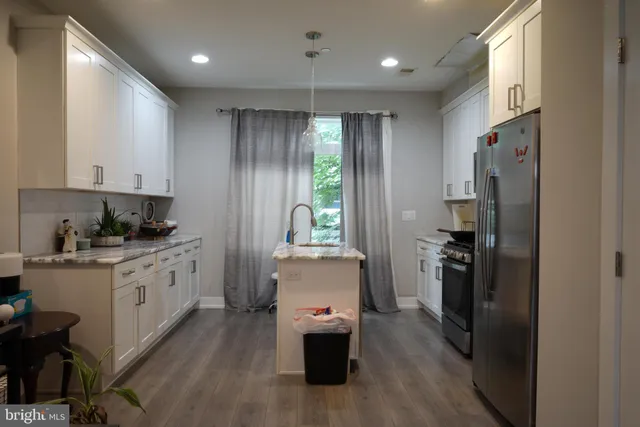 a view of a a dining room with furniture window and wooden floor