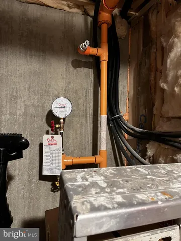 a bedroom with a bed a chair and mirror