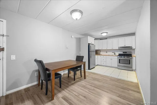 a kitchen with stainless steel appliances wooden floors and wooden cabinets