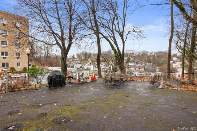 a view of a street with a large tree