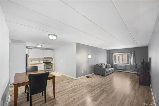 a dining room with furniture and wooden floor
