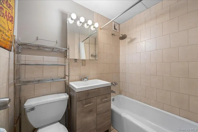 a bathroom with a toilet a sink and bathtub