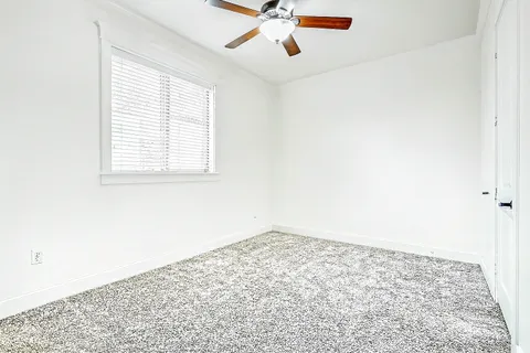 a bathroom with a granite countertop toilet a sink and a bathtub