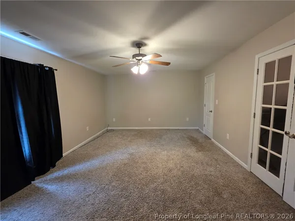 an empty room with closet and a window