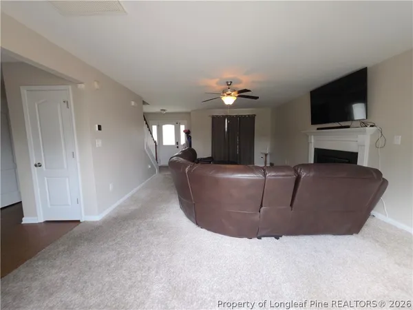 a living room with fireplace furniture and a flat screen tv