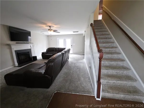 a living room with furniture and a fireplace