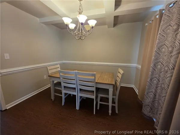 a view of a dining room with furniture and chandelier