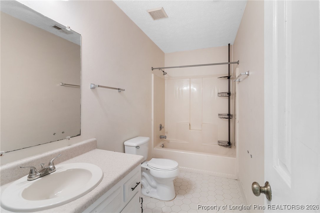 2924 Walden Road Fayetteville, NC 28303 - Photo 34 of 44 a bathroom with a sink toilet a shower and a mirror