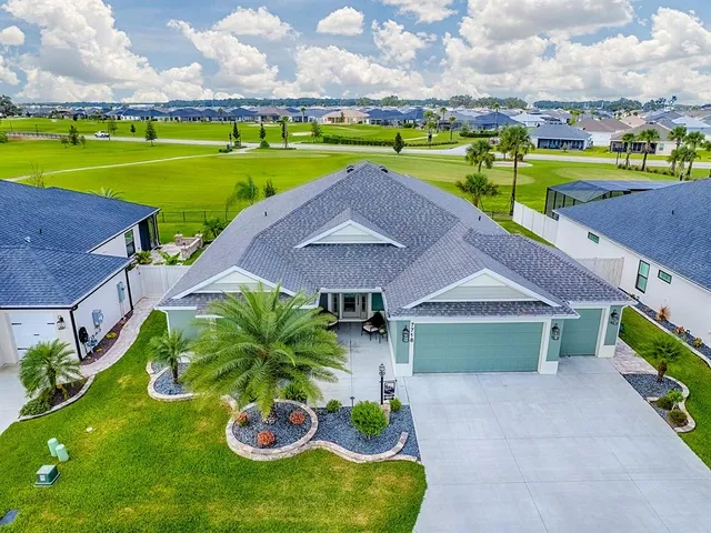 an aerial view of a house with a yard basket ball court and outdoor seating