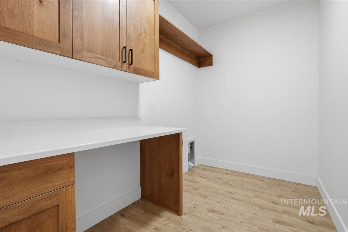 2175 Austin Way Fruitland, ID 83619 - Photo 18 of 30 Laundry area with light wood-style flooring, an office area, and cabinet space