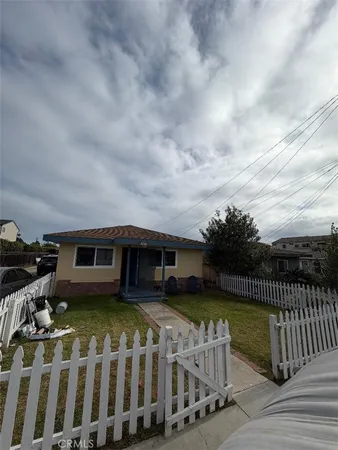 a view of a house with wooden deck and furniture