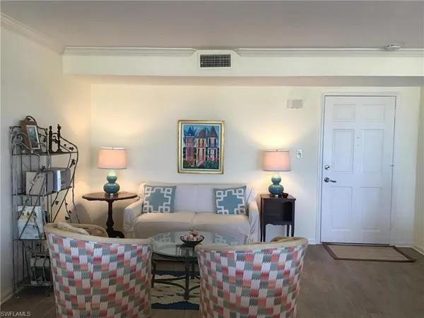 a living room with furniture and a lamp