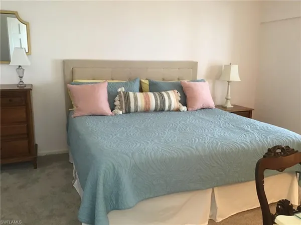 a bedroom with two beds and painting on the wall