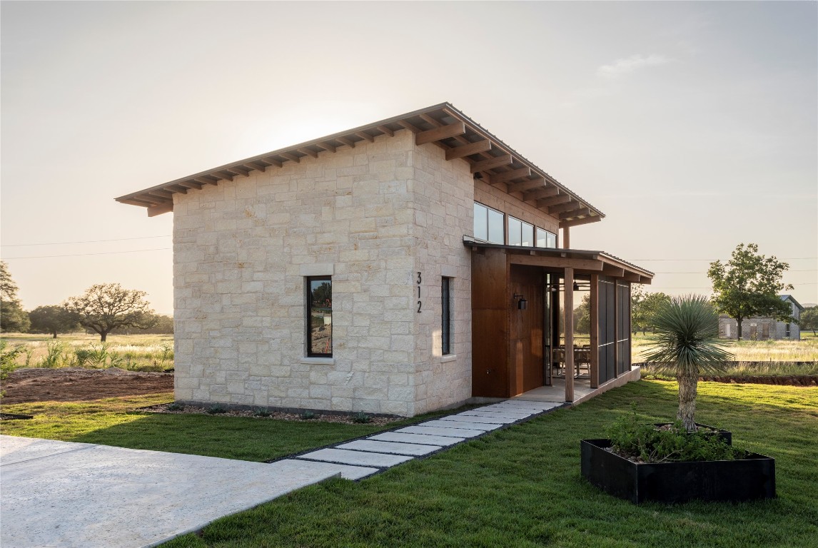 9361 Highway 290, Unit 8 Hye, TX 78635 - Photo 21 of 39 a front view of a house with garden
