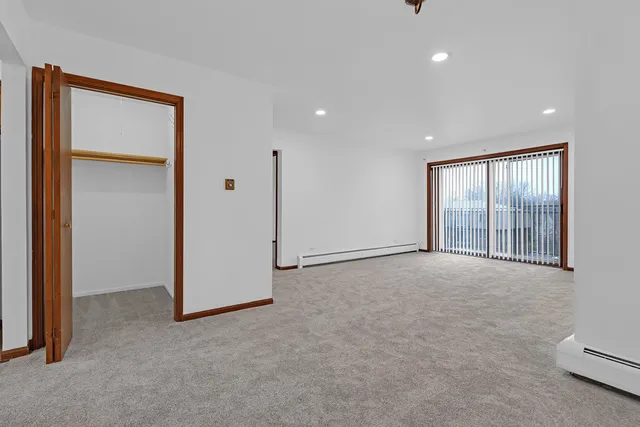 an empty room with windows and closet