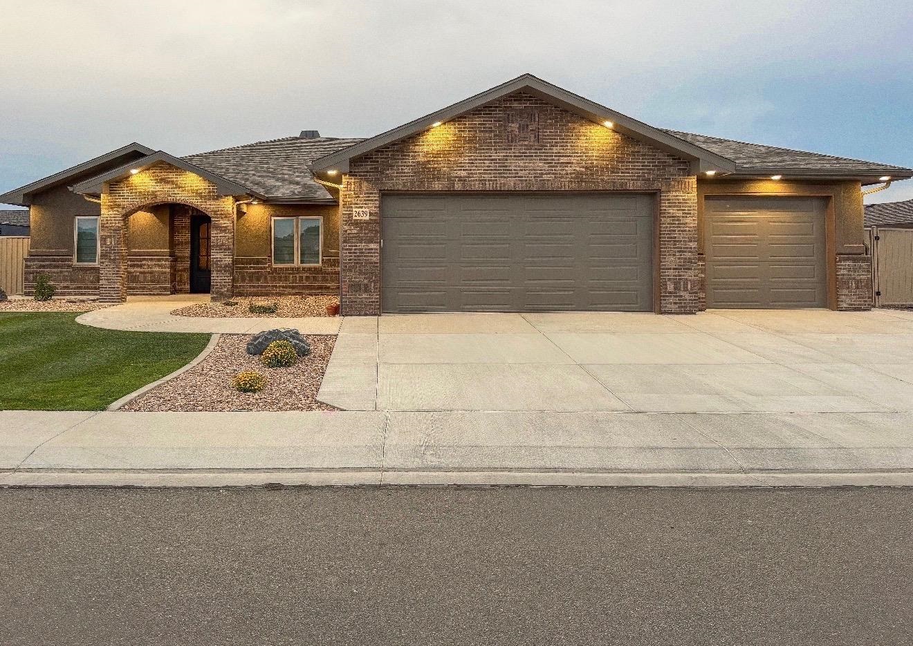 2639 Emerald Ridge Lane Grand Junction, CO 81506 - Photo 1 of 39 a front view of a house with a yard and garage
