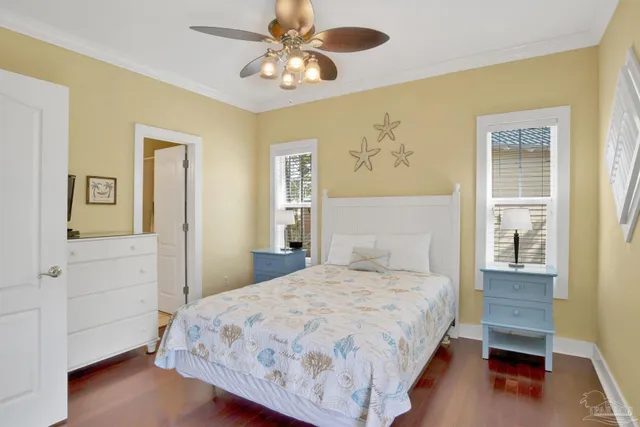 a bedroom with a bed chandelier and a window
