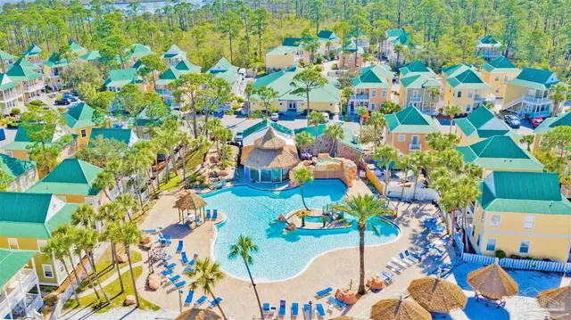 a view of a house with a yard and sitting area