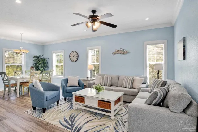a living room with furniture ceiling fan and a window