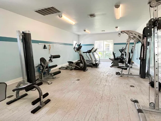 a view of a patio with furniture and a table under an umbrella