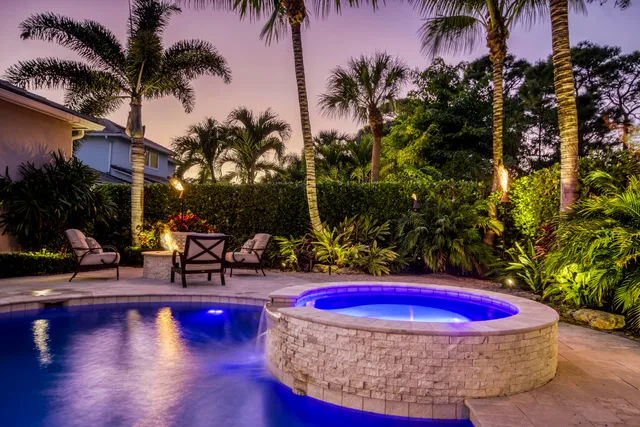 a living room with furniture a chandelier and a flat screen tv