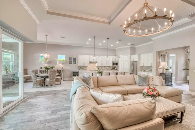 a view of swimming pool with chairs and palm tree