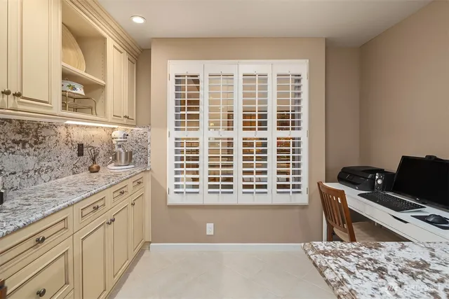 a bathroom with a granite countertop sink a toilet and a mirror
