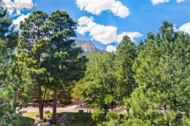 an aerial view of residential house with outdoor space and trees all around