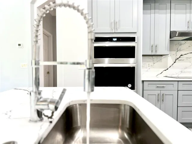 a kitchen with a sink and a refrigerator