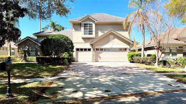 a view of a house with a yard and street
