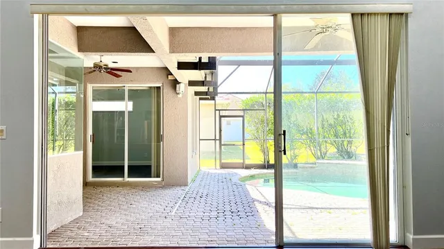 a view of a porch with a floor to ceiling window and wooden fence