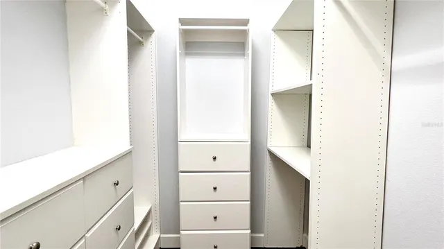 a spacious bathroom with a tub sink and mirror