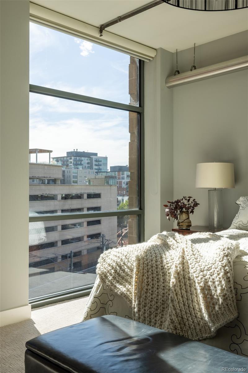 2100 16th St Mall, Unit 607 Denver, CO 80202 - Photo 16 of 46 a bedroom with a bed and wooden floor