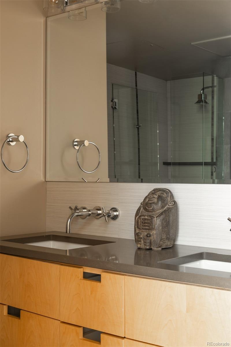 2100 16th St Mall, Unit 607 Denver, CO 80202 - Photo 21 of 46 a bathroom with a sink and mirror